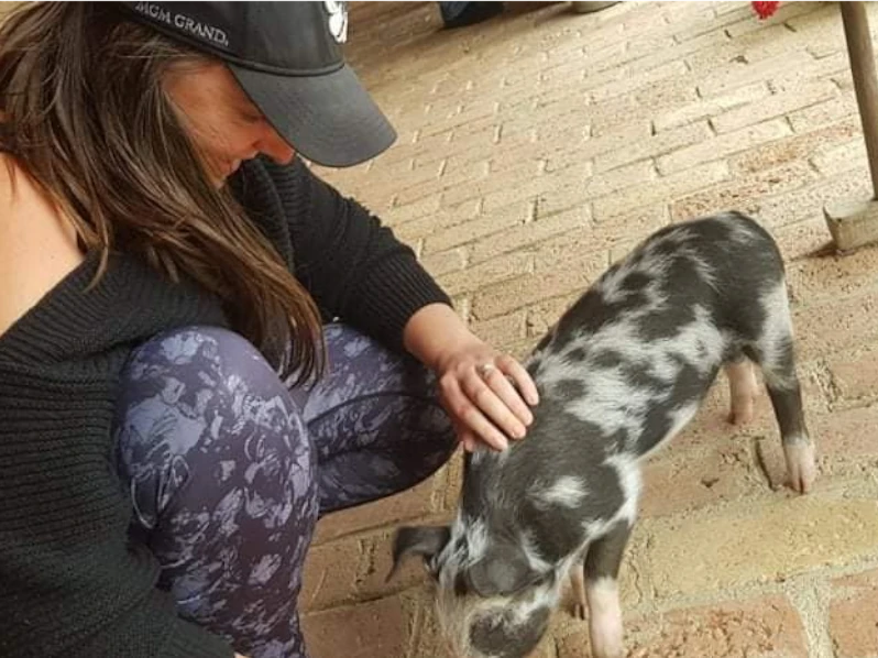 Laura Helen with a pig